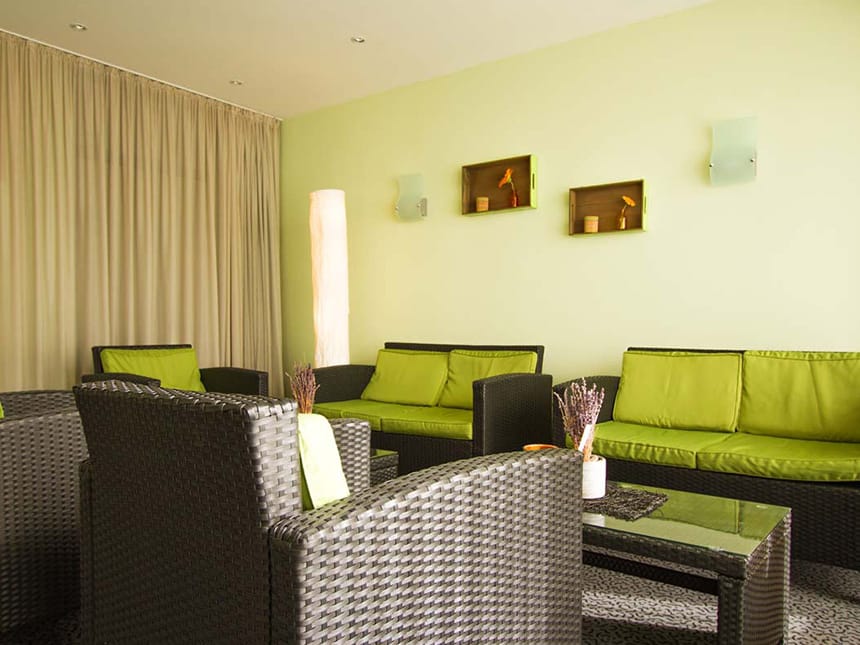 Loungebereich mit Sitzmöbeln und grünen Polstern