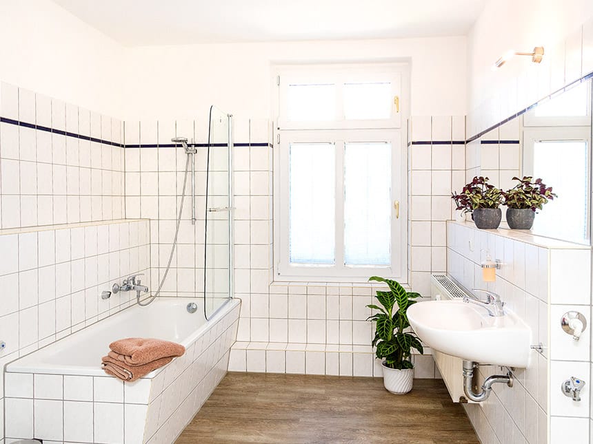 großzügiges Badezimme mit Badewanne, Waschtisch, Spiegel und Ablage